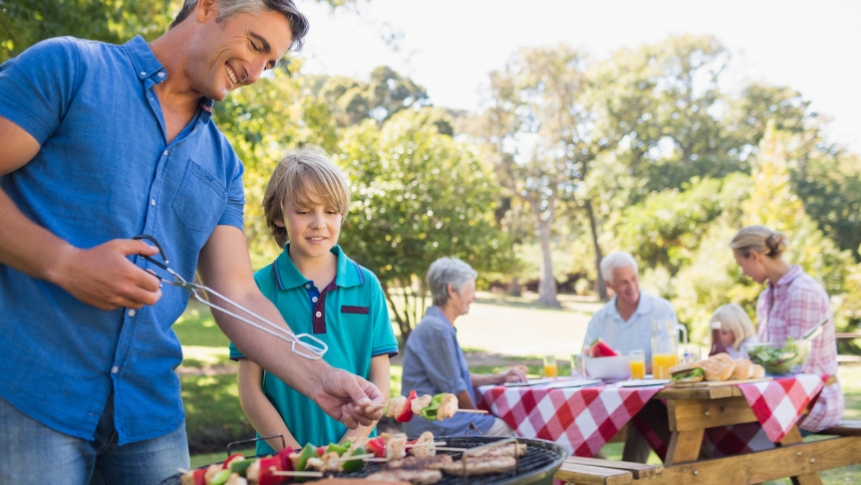 Father enjoying a family barbecue near Lake Lewisville in The Colony TX as part of Father's Day gift ideas for dads