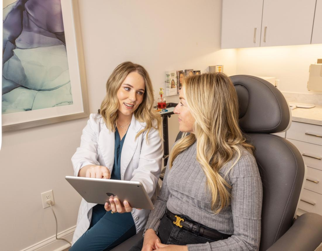 Provider discussing a personalized summer skin rejuvenation treatment plan with a patient at Specialty Wellness in The Colony, TX